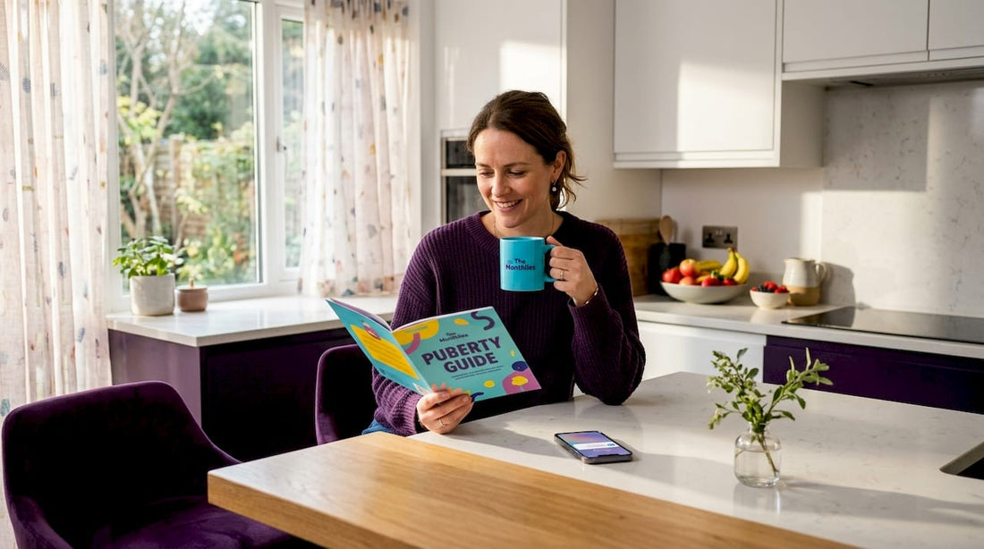 Parent reading a puberty guide in kitchen