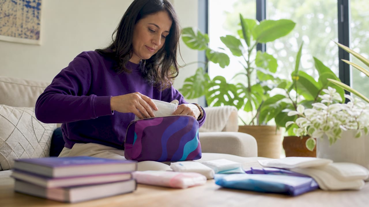 Mother assembling a period kit for daughter