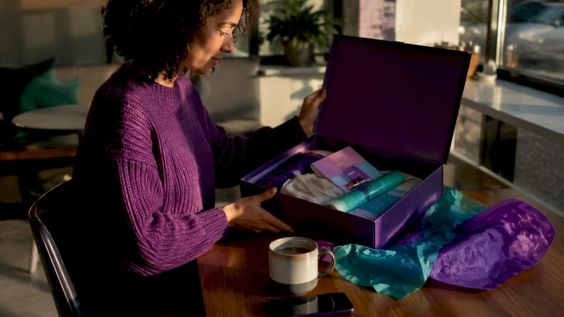 Parent unpacking puberty preparation kit on kitchen table
