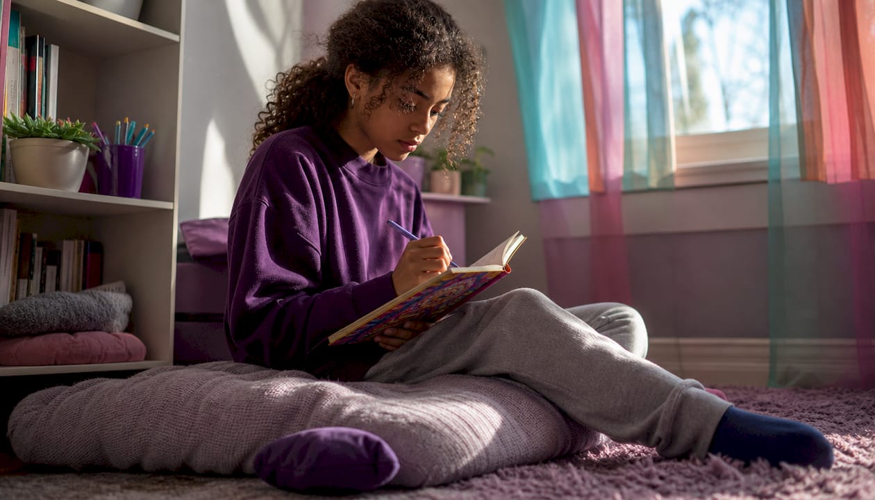Teen girl studying at home during period