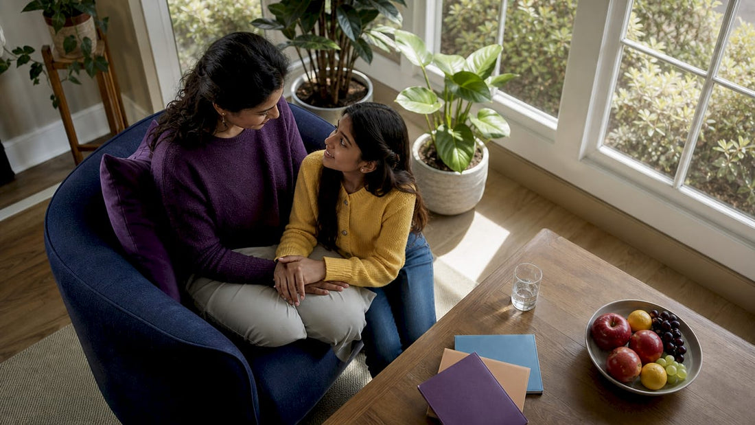 Mother talking gently to daughter indoors