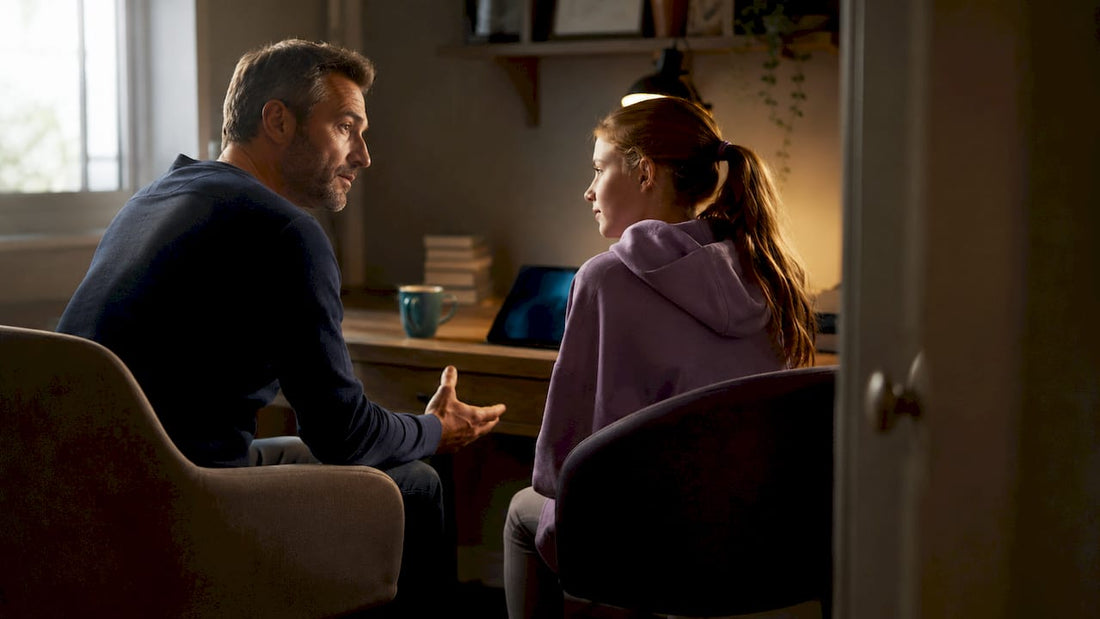 Father speaking supportively with daughter at home